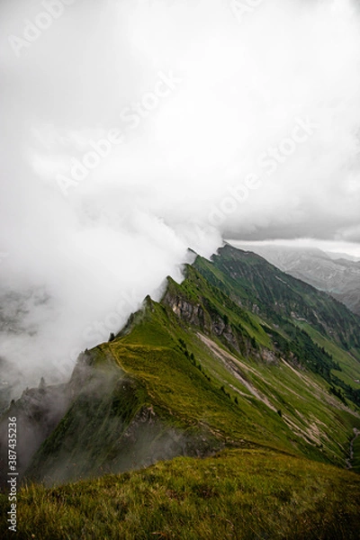 Fototapeta mountain peak in the clouds. top of mountains. Swiss alps