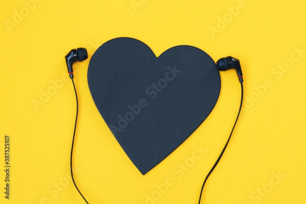 Fototapeta Black heart listning to music on background