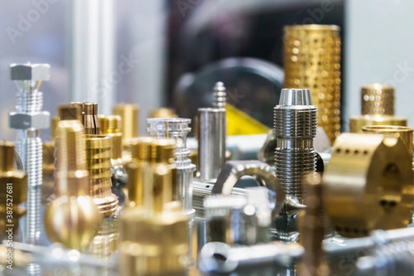 Fototapeta different shapes and sizes of parts turned on a lathe or milling machine. The details of processing of metal