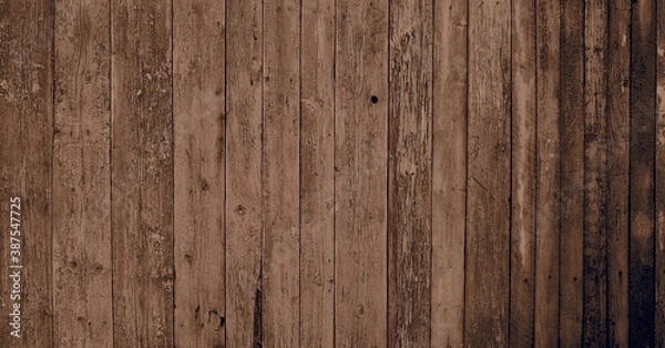 Fototapeta Wooden natural background with light sepia art processing.Fragment of old wooden wall cladding.