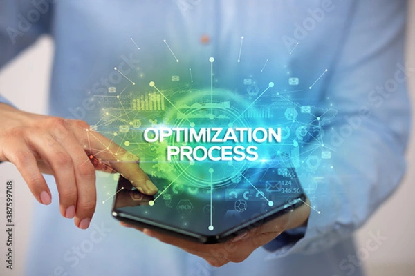 Obraz Businessman holding a foldable smartphone with OPTIMIZATION PROCESS inscription, new business concept