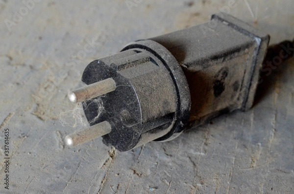 Fototapeta wide black plastic plug for socket