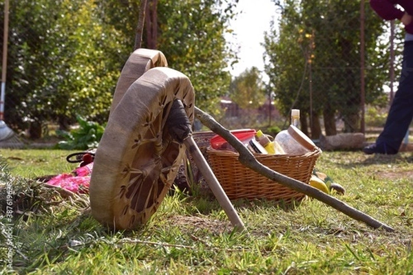 Fototapeta Leather drums with their sticks and basket with aromatic plants and offerings for the temazcal.