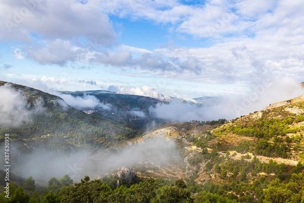 Fototapeta Confrides mountain´s port in the morning one day with low fog and clouds.