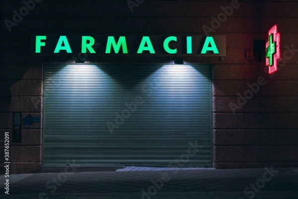 Obraz Pharmacy closed at night with a bright green light
