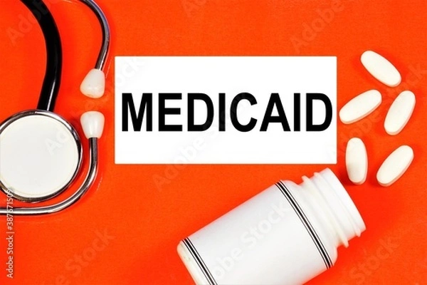 Fototapeta Medicaid. Text inscription on the background of medicines. The state program covers medical expenses for people with limited incomes.