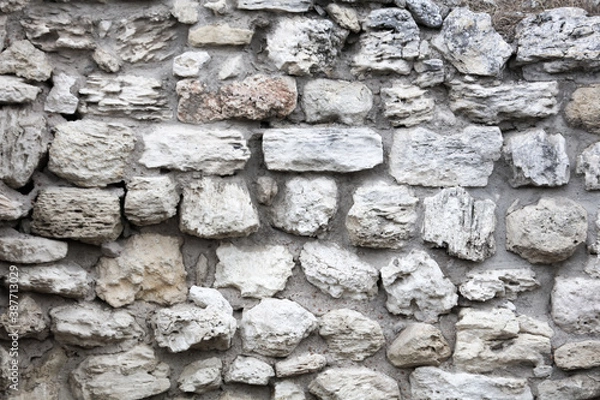 Fototapeta Stones in the wall of the house as an abstract background.