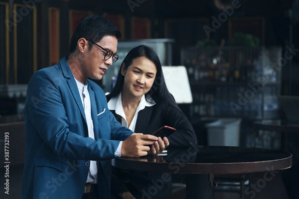 Fototapeta Executive business people talking and discussing with partner or colleagues in co-working space area, brainstorming and meeting team by using laptop or tablet concept