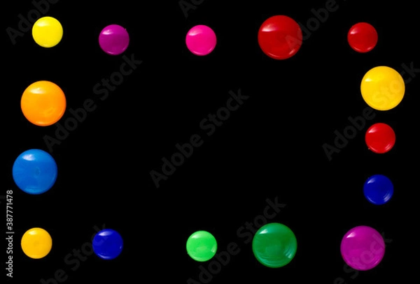 Fototapeta background frame made of colored magnetic paper clips on black background