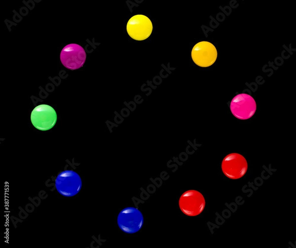 Fototapeta background frame of colored magnetic paper clips in the form of a circle on a black background