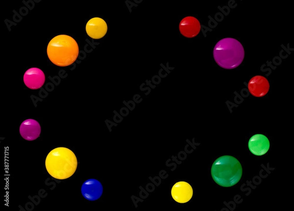 Fototapeta background frame made of colored magnetic paper clips on black background with space for text