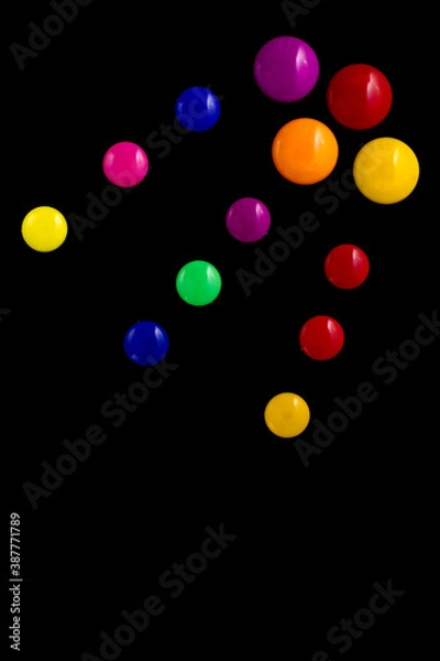 Fototapeta background frame made of colored magnetic paper clips on black background with space for text