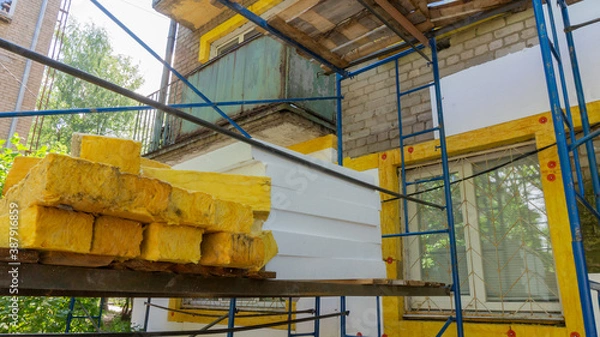 Fototapeta Foam insulation on scaffolding