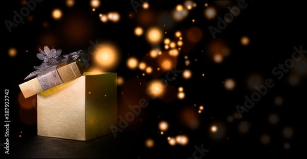 Obraz Christmas box expelling colored balls with black background