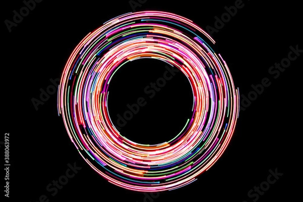 Fototapeta Neon circle lines. Empty copy space inside. Colorful led lights. Long exposure rotation photo. Round light shape isolated on black. Shiny glittering ring.