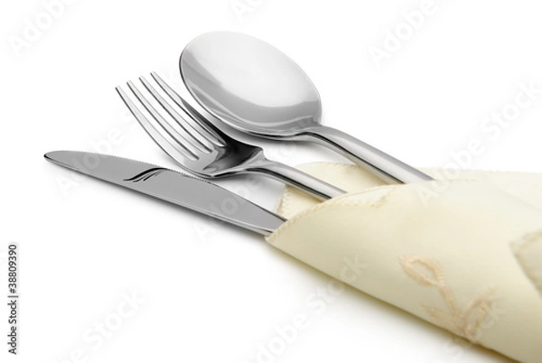 Fototapeta Spoon, fork and a knife lie on serviette