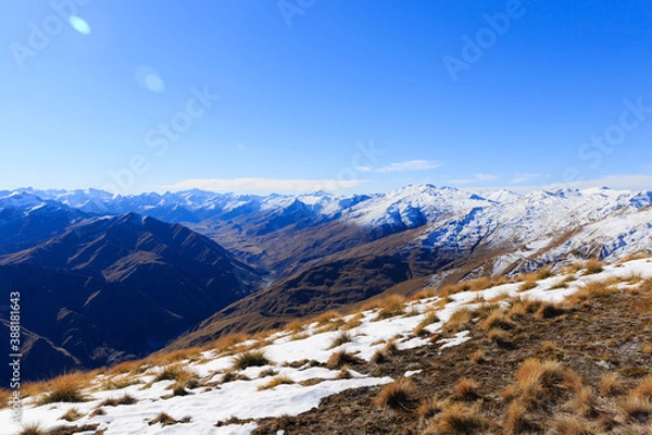 Obraz Snow topped mountains landscape view with dry fields around in Queenstown, New Zealand.