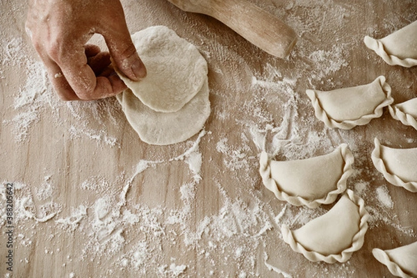 Fototapeta hands kneading dough, baker, the Baker's hands, dough, hands in the flour, dumplings, handmade dumplings, ravioli