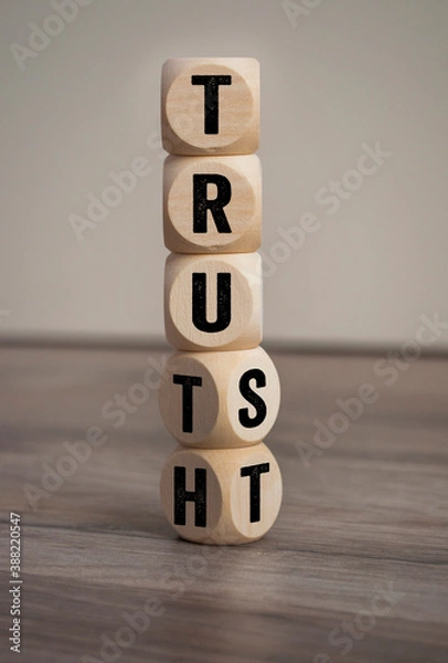 Fototapeta Cubes, dice or blocks with trust and truth on wooden background