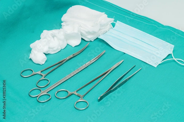 Fototapeta Part of a set of instruments, swabs, gauze and mask for surgical treatment of wounds and for minor and major surgical interventions