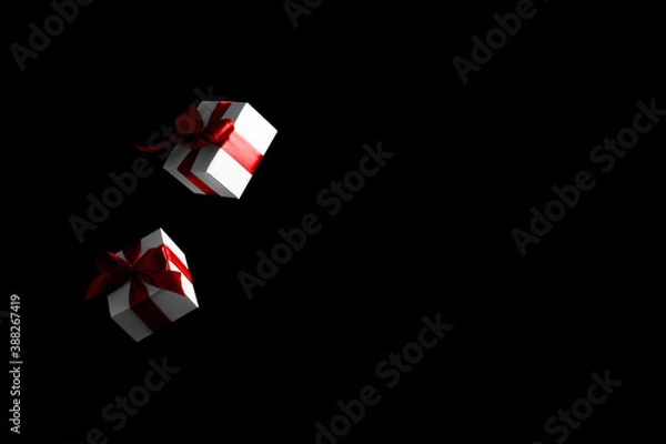 Fototapeta Online christmas. White gift box with red ribbon isolated on black background in Black Friday concept. Decoration and copy space for your text.