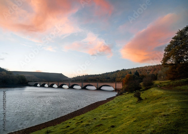 Obraz bridge over the river with pink clouds and blue sky