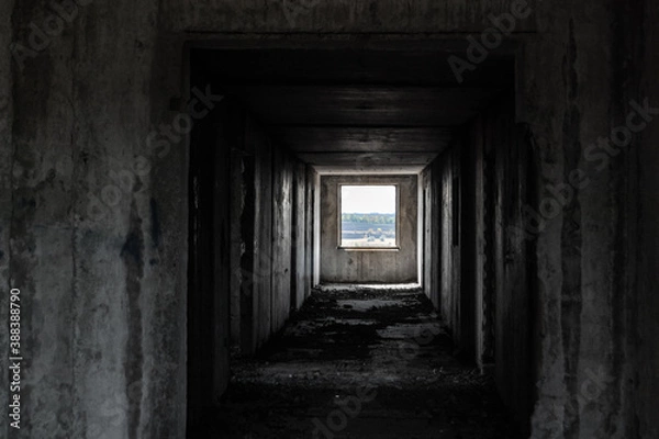 Fototapeta Dark cold weathered abandoned floor way with lighted picture like window in the end. From darkness to new beginning