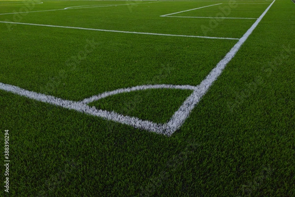 Fototapeta Artificial grass soccer field. Corner kick line of ball and a soccer field , football field , background texture