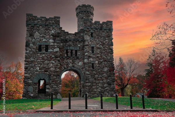 Fototapeta Ancient stone tower on a beautiful late autumn afternoon