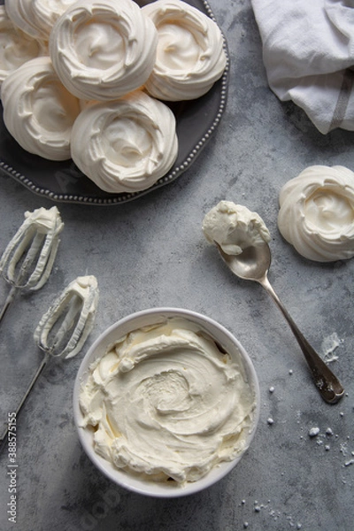 Fototapeta Cooking meringues Pavlova cakes from egg whites and sugar. Abstract food background, copy space. Top view.