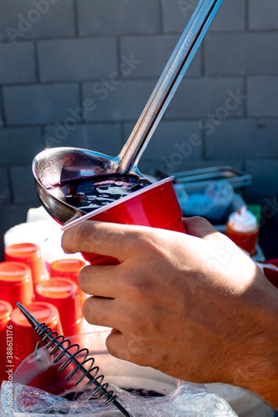 Fototapeta Pouring Punch into a Red Solo cup