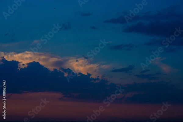 Fototapeta Heavy cloudy sky at sunset. A landscape of beautiful nature