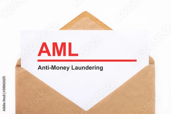 Obraz A white sheet with the text aml lies in an open craft envelope on a white background with copy space. Business concept image