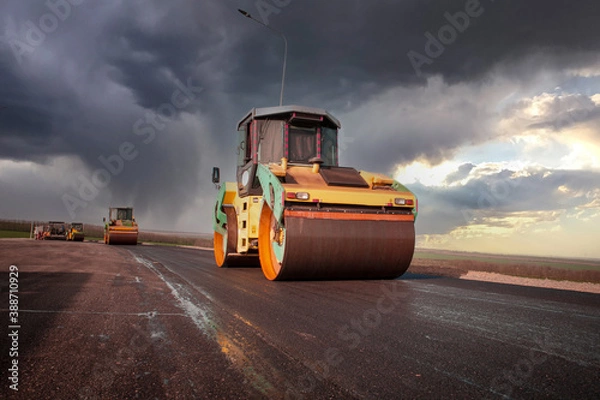 Fototapeta Large view on the road rollers working on the new road construction site