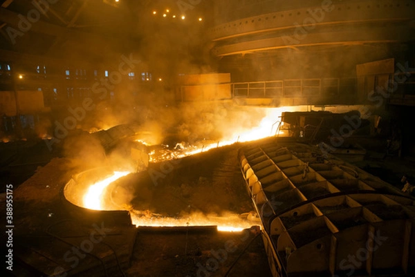 Obraz blast furnace iron tapping. Hot steel is poured into another pan