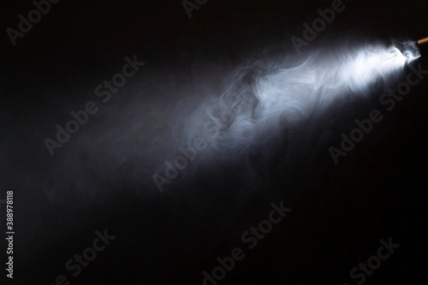 Obraz spotlight, ray of light on smoke. black backround
