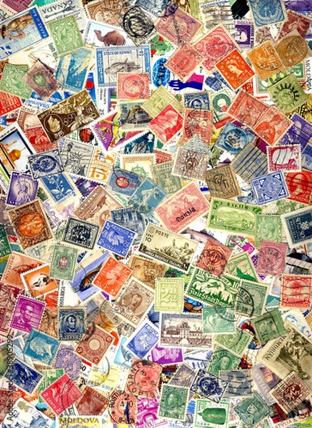 Fototapeta A pile of different postage stamps from around the world