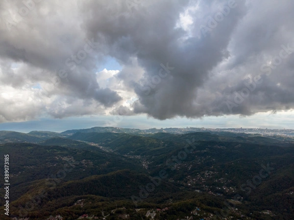 Obraz Aerial view over agricultural fields and road. Dark clouds in the sky
