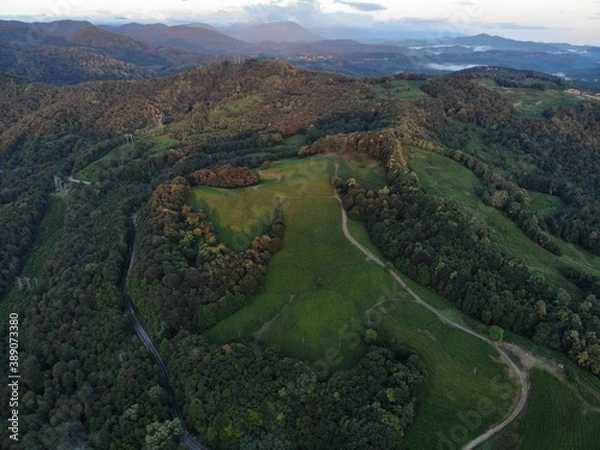 Obraz Aerial view over agricultural fields and road. Dark clouds in the sky