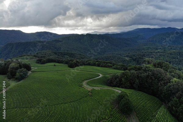 Obraz Aerial view over agricultural fields and road. Dark clouds in the sky