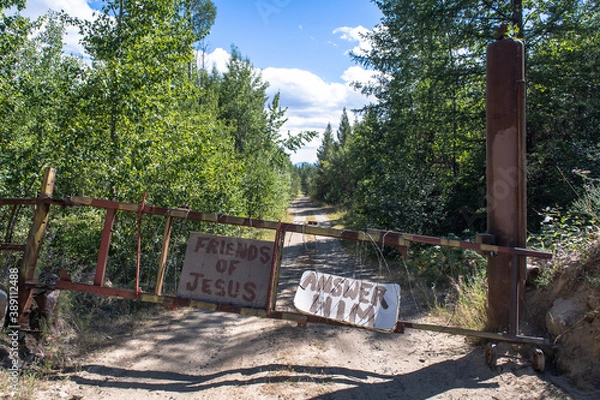 Fototapeta Ominous Religious Signs Adorn Rusted Gate Landscape