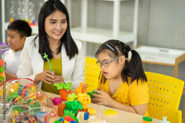 Obraz disability kid on wheelchair with Autism child in special classroom