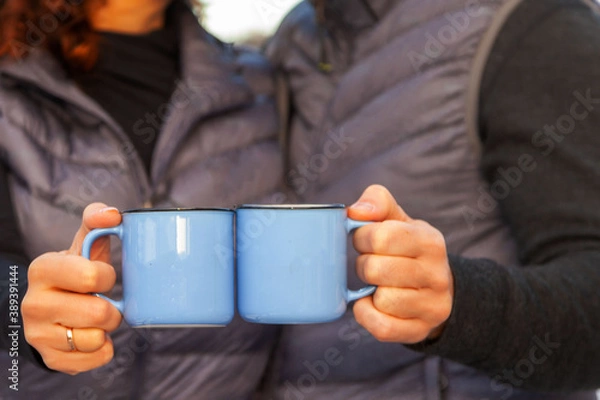 Fototapeta blue cups in the hands of a couple in love close-up, selective focus