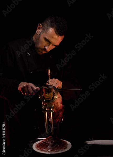 Fototapeta 

professional Iberian ham cutter making a still life and cover of Iberian ham, cheese and bread