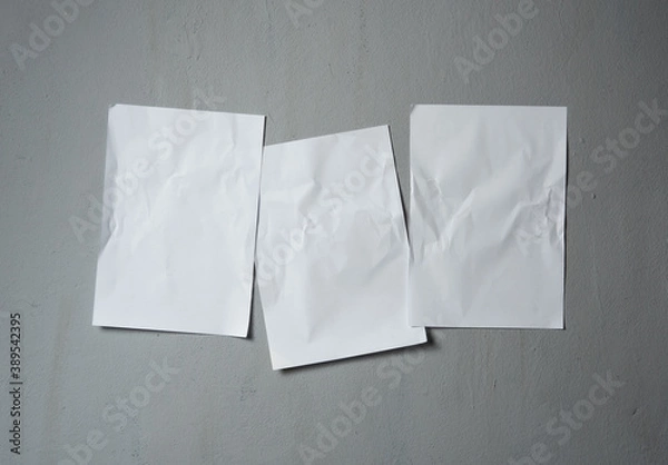 Obraz Empty old wrinkled white A4 paper stick on gray cement wall, changeable background. white paper note on gray