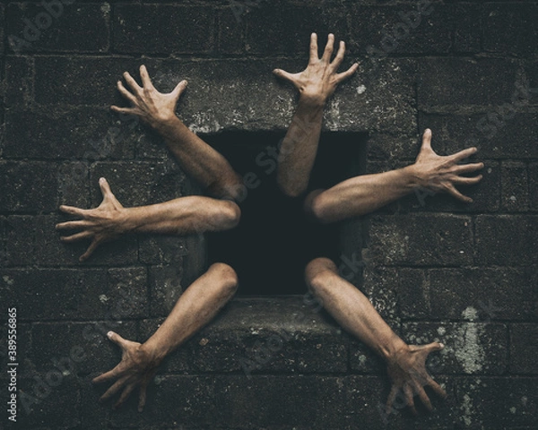 Fototapeta Zombie hands rising out from old damaged window. Darkness horror and halloween background concept.