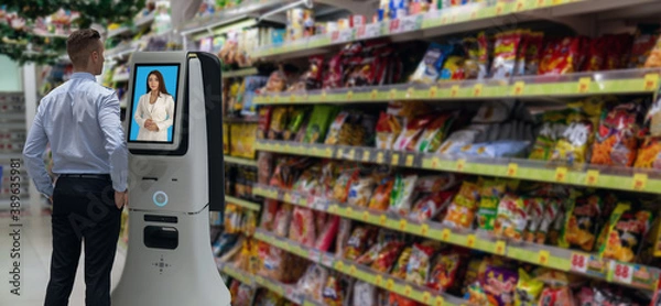 Fototapeta iot smart retail futuristic technology concept,man try to ask Shopkeeper รื  smart Digital Signage display in the shop or retail advice to choose select ,buy cloths and give a rating of products