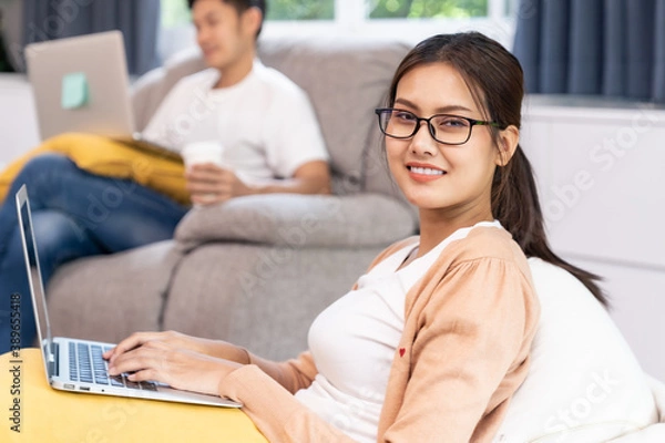 Fototapeta Quarantine couple working from home with laptop