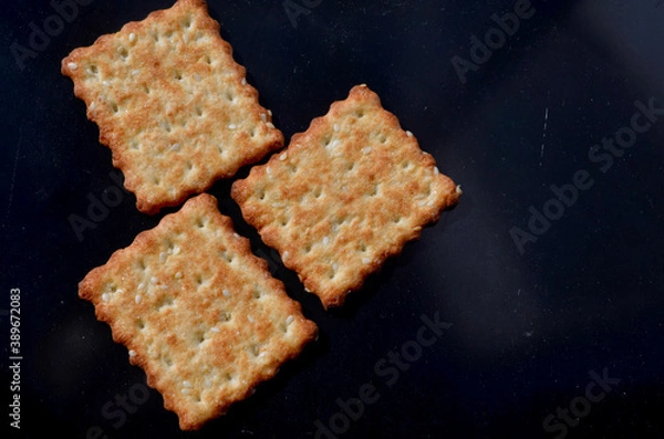 Fototapeta three square cookies on a dark background