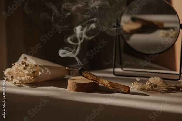 Obraz  palo santo with jet of smoke, mirror and dried flowers on a neutral background. Abstract trendy picture. Minimalistic wabi sabi style.